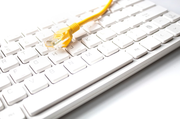 White keyboard with lan wire in business and network concept