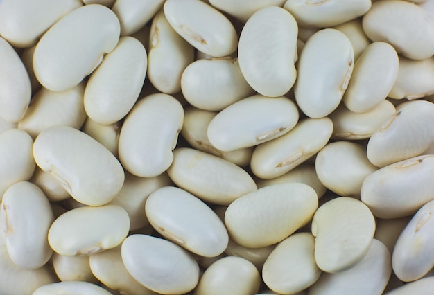 Photo white kidney beans background texture. vegan and vegetarian photo. ecological green food. close up, macro photo.