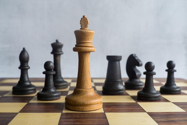 The white king surrounded by black chess figures