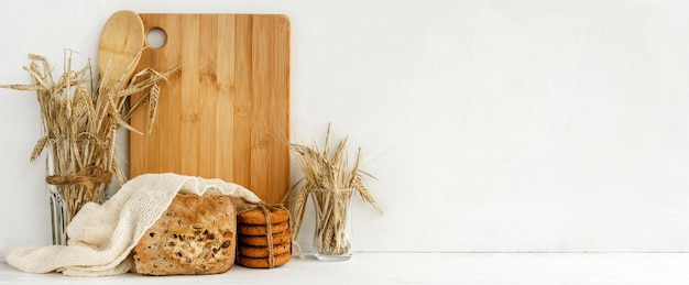 White kitchen banner oatmeal cookies bread and ears of grain on a white table Decorative Kitchen Accessories