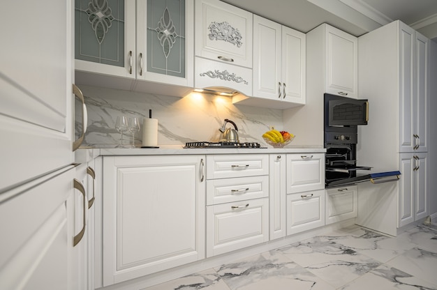 White kitchen in classic style, front view