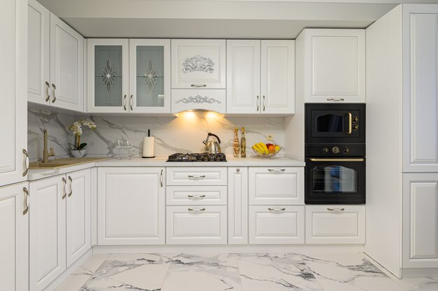 White kitchen in classic style, front view