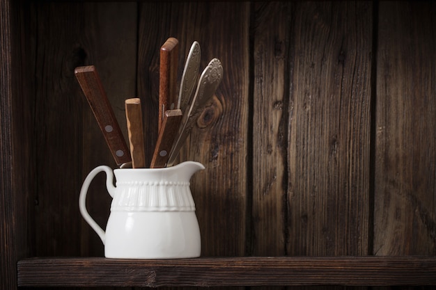 White kitchen dishware on old dark wooden table