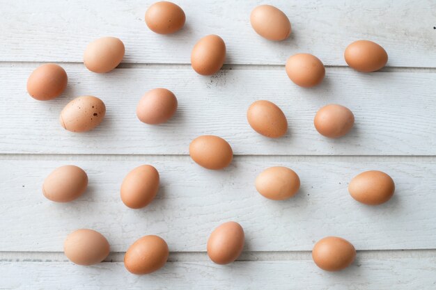 White kitchen table texture background with fresh eggs set.