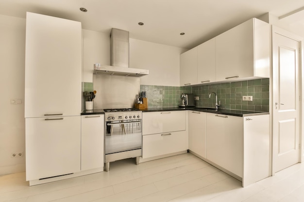 a white kitchen with white appliances and white cabinets