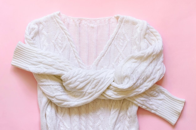 White knitted cotton pullover on pink background Cozy Autumn Winter look