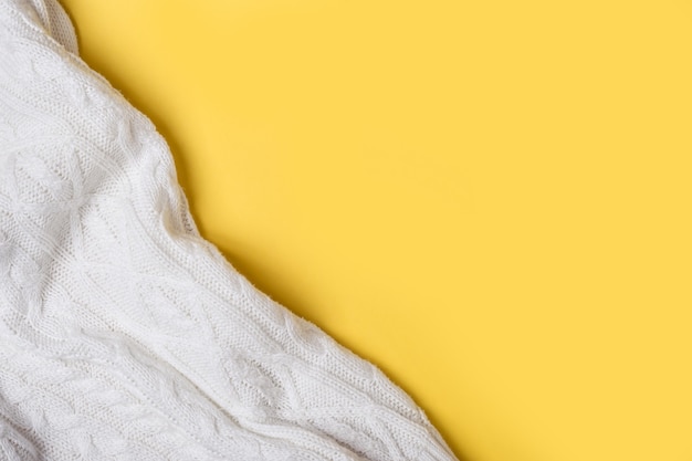 White knitted soft plaid on yellow background