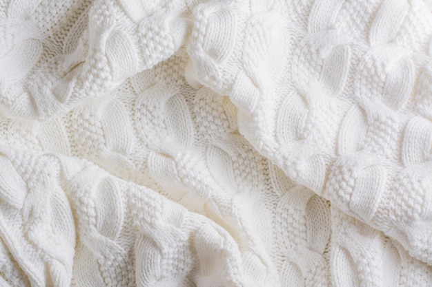 White knitted textured wool background from cozy and warm clothes