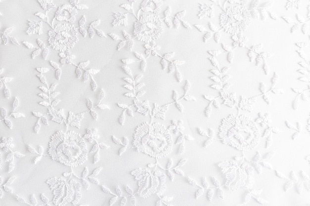 White lace with small flowers on the white background