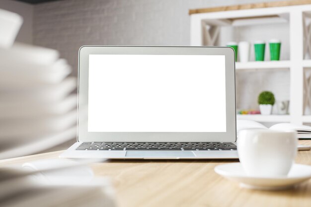 White laptop and coffee cup