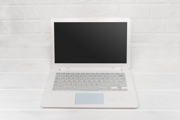 White laptop on the table close up