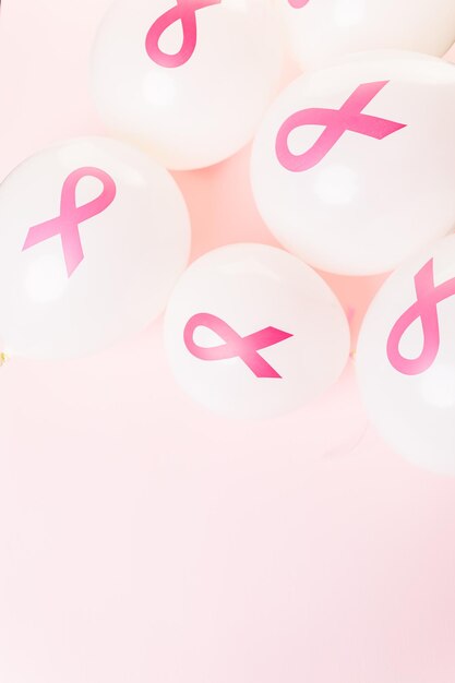 White latex balloons with pink ribbons.