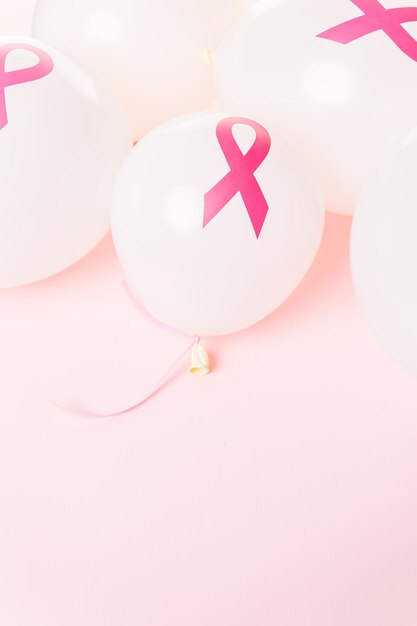 White latex balloons with pink ribbons.