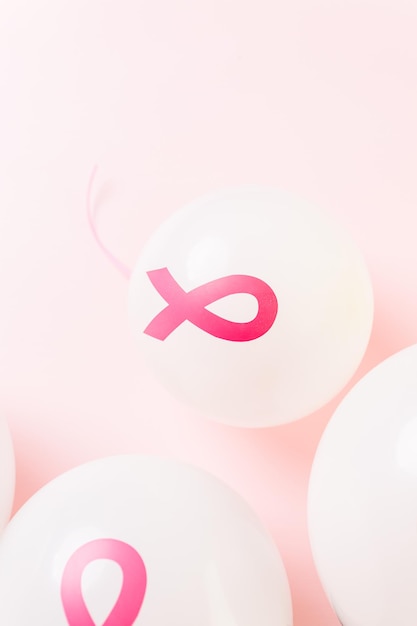 White latex balloons with pink ribbons.