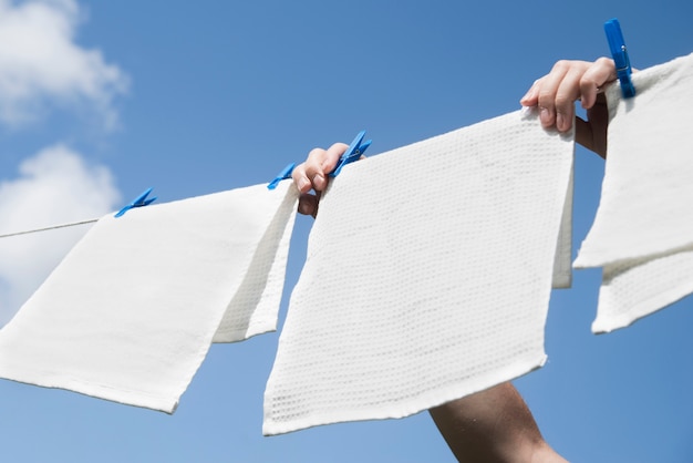 Photo white laundry hanging on a string outdoors