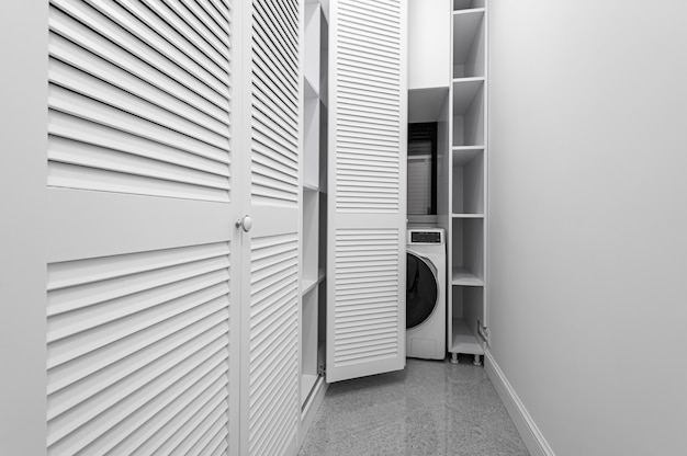 White laundry space inside wardobe room in new apartment