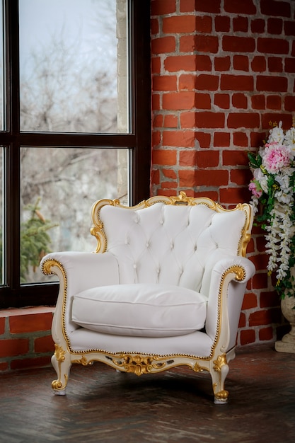 White leather armchair near window