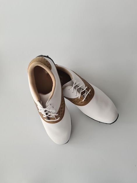 White leather golf boots with brown inserts