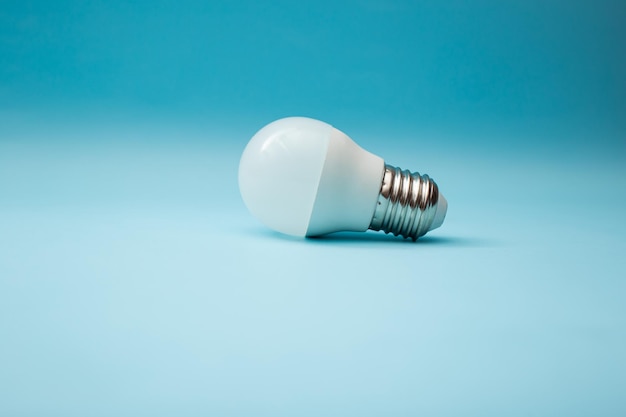 White light bulb on a blue background