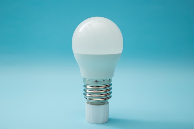 White light bulb on a blue background