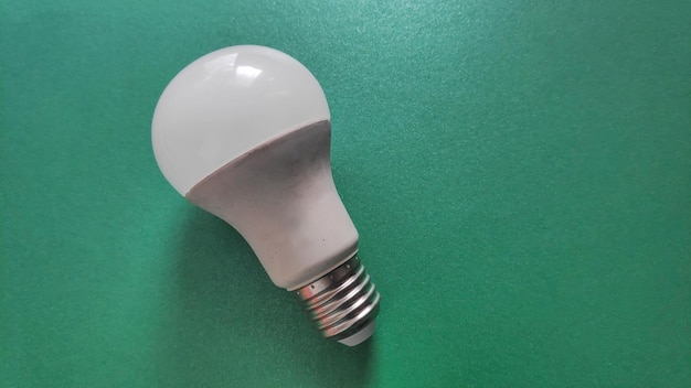 White light bulb on colored background in pastel colors