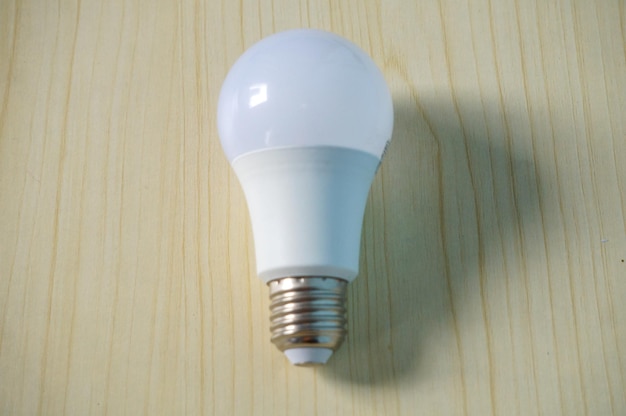 White light bulb on wooden background Energy concept