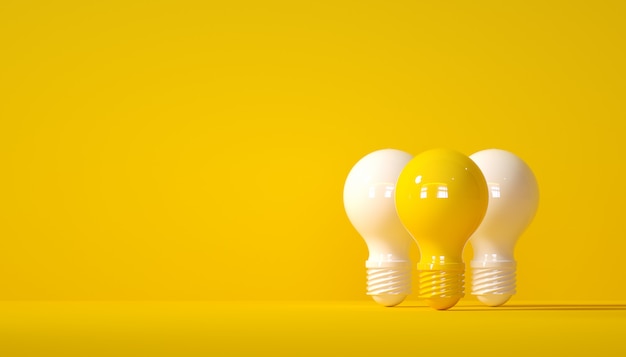 White light bulb and yellow light bulb on yellow background bright idea concept