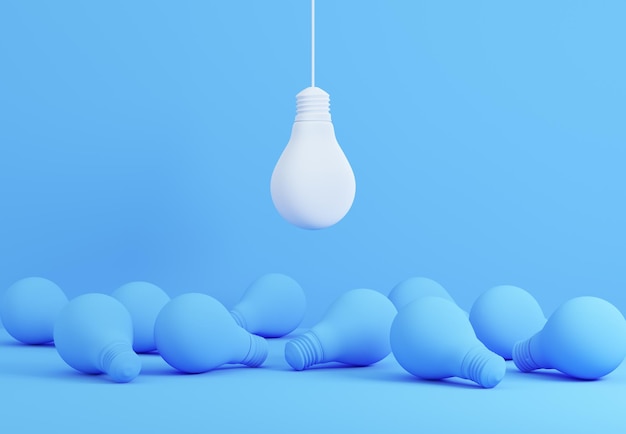 White lightbulb hanging above blue lightbulbs laying on floor Creative idea and leadership concepts