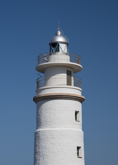 White lighthouse against a blue sky closeup Port de Soller Mallorca Spain