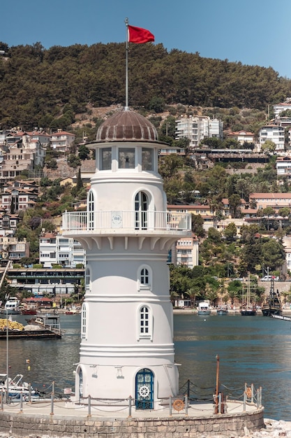 White lighthouse in the port off the coast Blue sky Marina