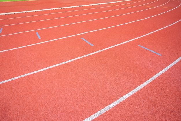 White lines of stadium and texture of running racetrack red rubber racetracks 