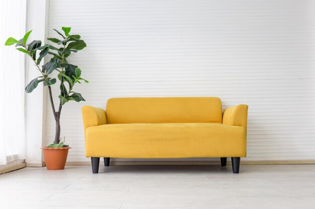 White living room interior with modern yellow fabric sofa with empty white wall background