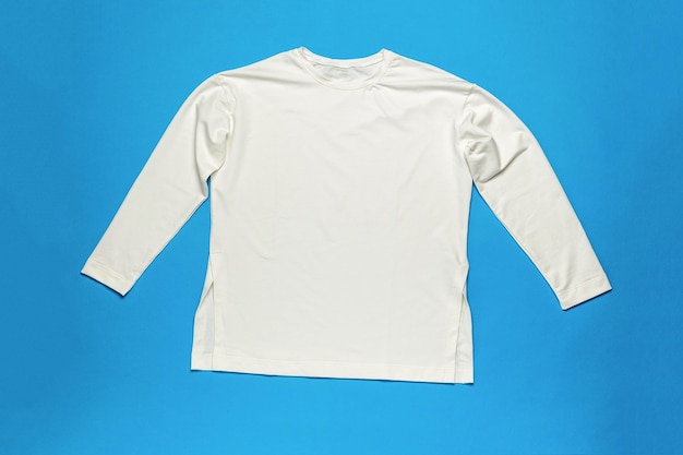 White long sleeve Tshirt on a blue background