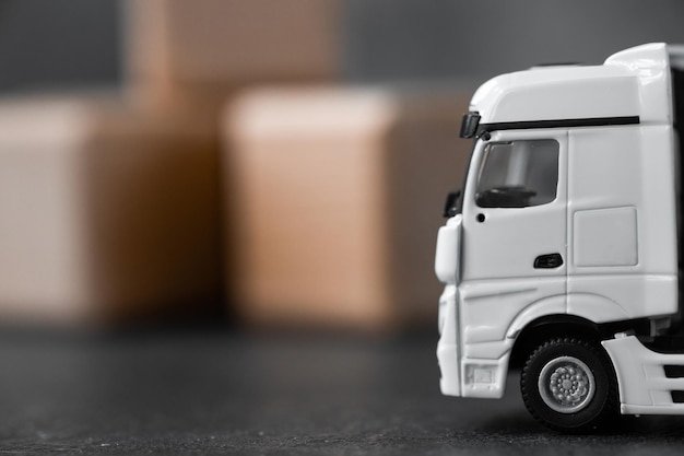 White long truck miniature with a trailer on dark background Clipping path included