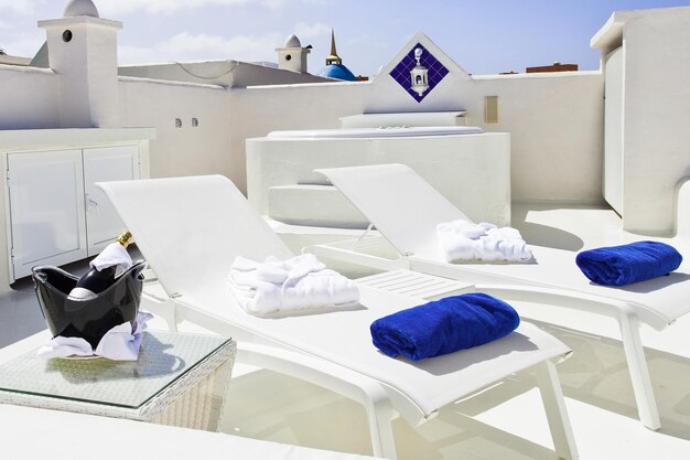 white loungers with blue towels