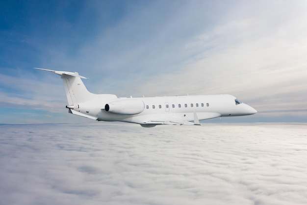 White luxury executive aircraft flies in the air above the clouds