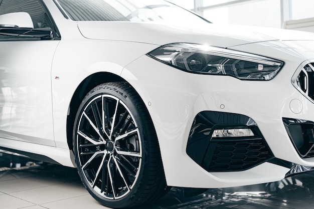 White luxury passenger car standing inside salon