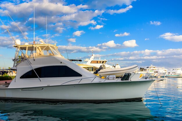 White luxury yacht in a sea harbor of hurghada, egypt. marina\
with tourist boats on red sea