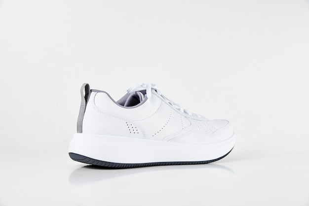 White male sneaker on a white background isolated. Fashion stylish sport shoes, close up