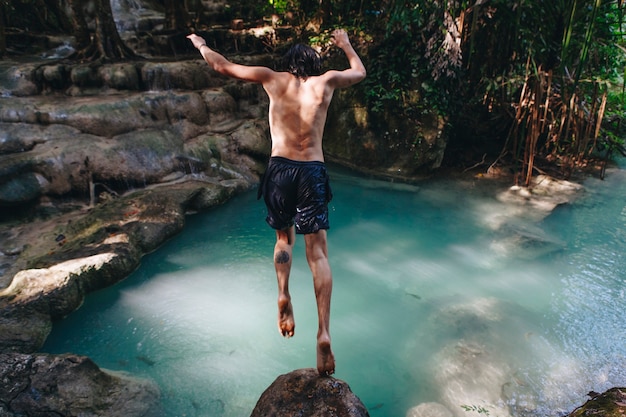 White man enjoying the waterfall