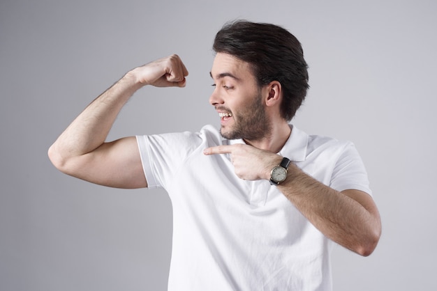 White man posing with biceps isolated on white background.