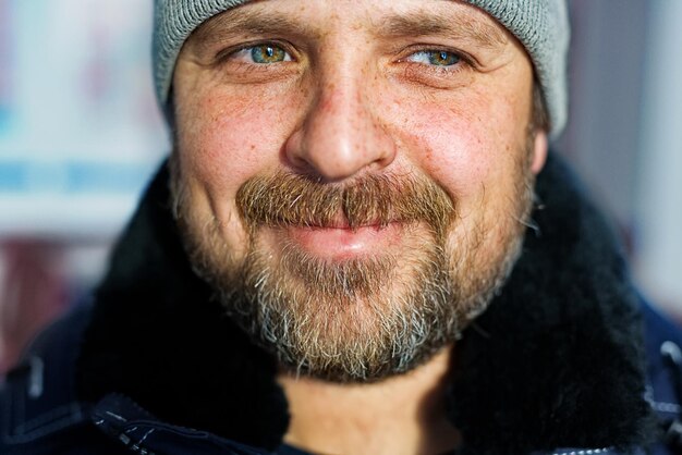 A white man with a beard looks away and smiles Portrait of a dreaming farmer closeup