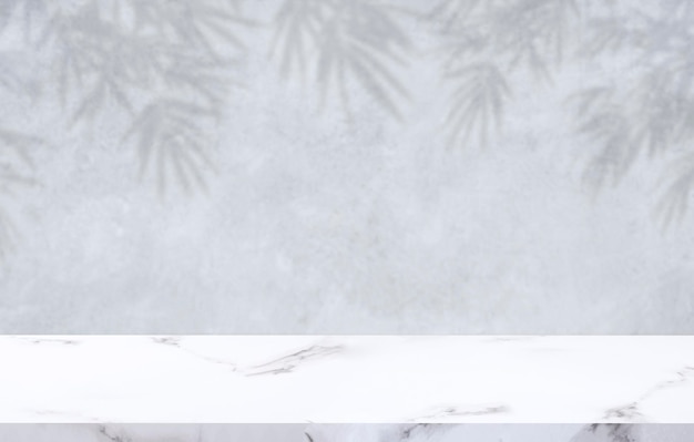 White Marble table top with leaves shadow on loft concrete wall surface in vintage style