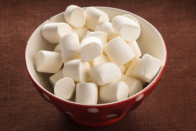 White marshmallows close up in a bowl