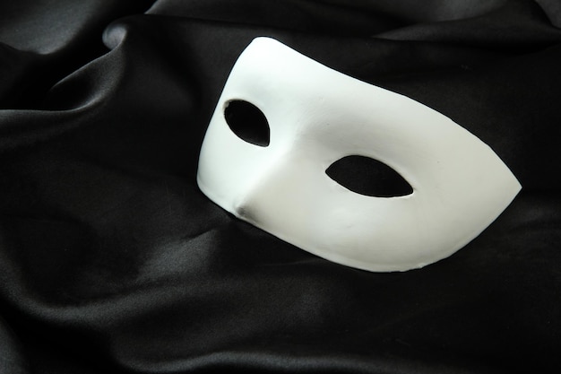 Photo white mask on black silk fabric