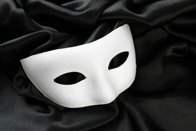 White mask on black silk fabric