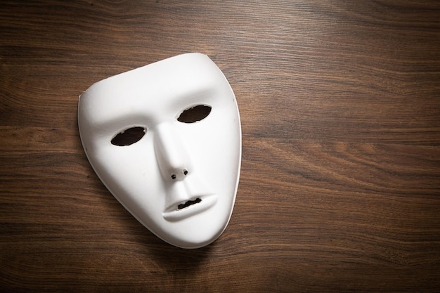 White mask on the wooden table