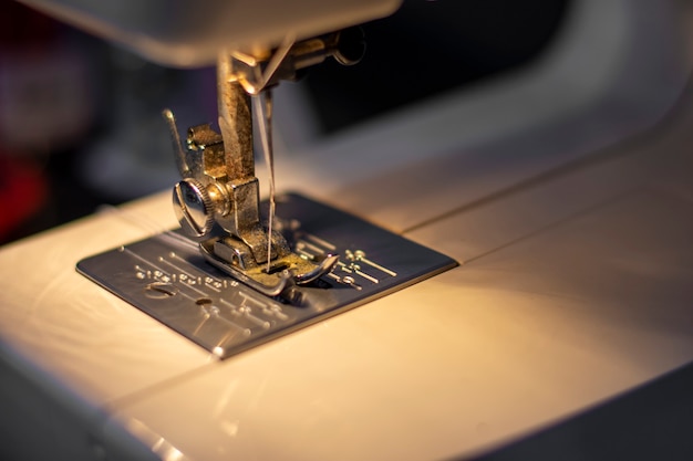 White mechanical sewing machine in the dark