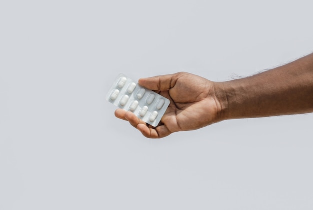 A white medicine pack holding on hand isolated on white background