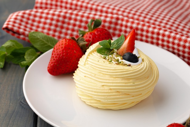 White meringue cake on plate served on table